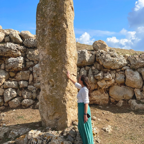Kristine Cassady beside an ancient standing stone