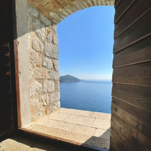 Open stone window looking toward blue water